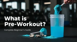 Colorful pre-workout supplement powder in scoop with shaker bottle and gym equipment, illustrating what is pre-workout for beginners