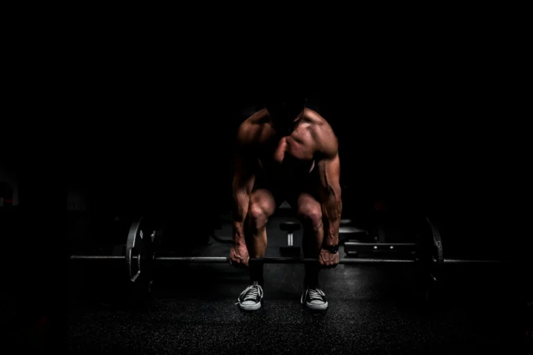 Athlete performing a deadlift with proper form, demonstrating excellent technique during a periodized strength training program