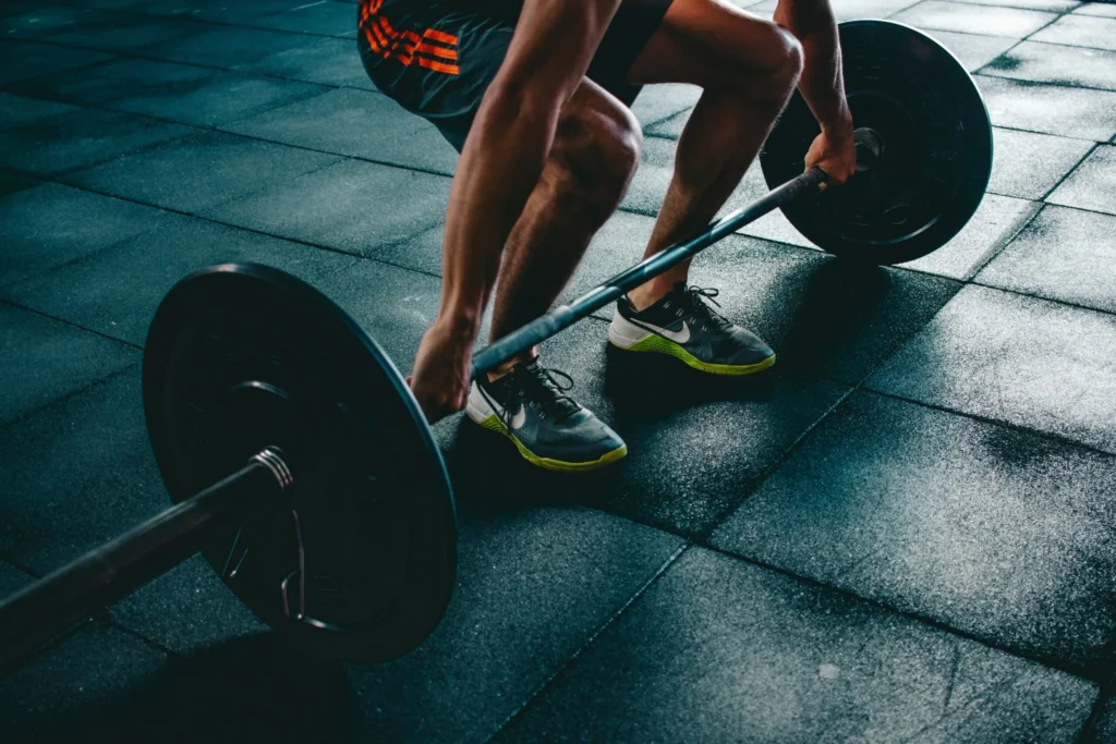 Athlete performing a deadlift with proper form, demonstrating excellent technique during a periodized strength training program.